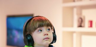 boy near white wooden shelf
