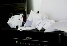 a pile of papers sitting on top of a black box