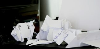 a pile of papers sitting on top of a black box