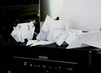 How to Send a Fax for Free Without Signing Up for a Paid Plan a pile of papers sitting on top of a black box