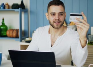 Digital Withdrawal, ADR, and Dark Patterns: Why the Interface Matters More and More for Online Sellers in Europe Man holding credit card while looking at laptop