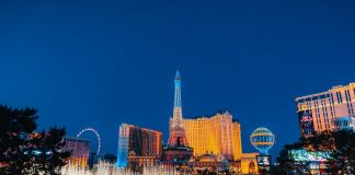 a city with a ferris wheel and buildings at night