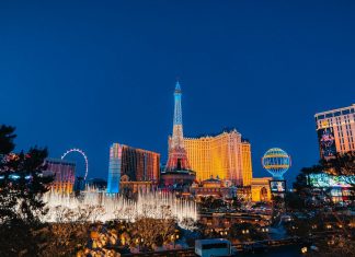 a city with a ferris wheel and buildings at night