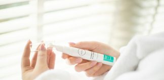 person holding white plastic tube