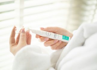 person holding white plastic tube