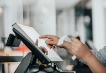 a person is using a pos machine in a store