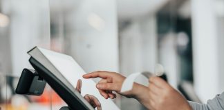 a person is using a pos machine in a store