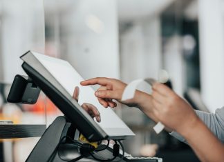 a person is using a pos machine in a store