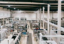 Cutting Glare, Not Corners: Lighting Upgrades That Improve Safety in Manufacturing a factory filled with lots of machines and equipment