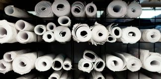 A rack full of rolls of white toilet paper
