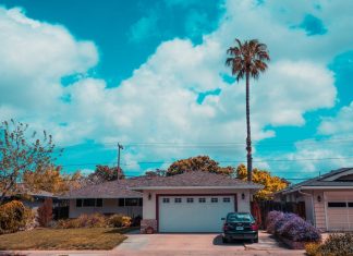 A Beginner’s Guide to Garage Door Springs: Types, Risks, and When to Call a Pro white and gray house with closed garage door