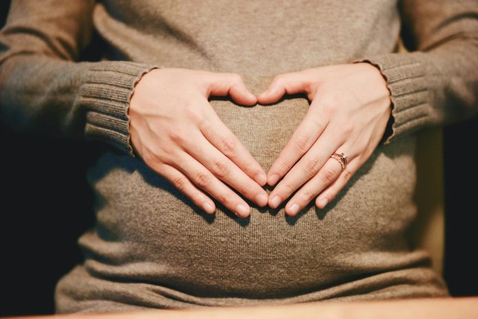 Photo by Suhyeon Choi person holding belly photo