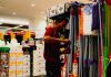 Man arranging cleaning supplies in a store