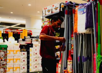 Man arranging cleaning supplies in a store