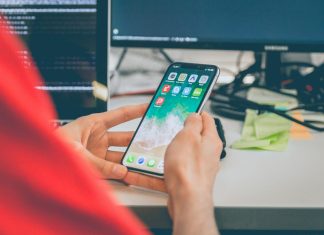 Flutter vs Cross-Platform Development: Is Hiring a Flutter Specialist Worth It Over a Generalist? person using silver iPhone X