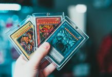 Trading Card Care Tips for Serious Collectors person holding yu gi oh trading card