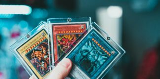 person holding yu gi oh trading card