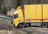 What Should You Do Immediately After a Commercial Truck Accident? A yellow semi-truck is in a roadside accident.