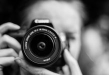 person taking photo using Canon camera in shallow focus lens