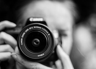 Why a Photography Course for Beginners Is the Fastest Way to Improve Your Skills person taking photo using Canon camera in shallow focus lens