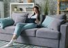 How Technology Is Quietly Rewriting the Rules of Modern Living Woman wearing headphones uses tablet on couch.