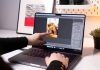 Vidmud Photo Enhancer and AI Photo Editor Review: Is It Worth Using in 2026? A person sitting in front of a laptop computer