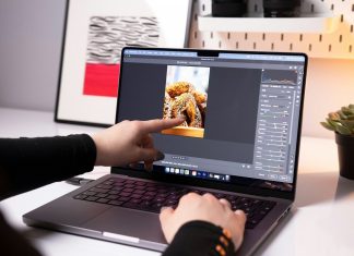 Vidmud Photo Enhancer and AI Photo Editor Review: Is It Worth Using in 2026? A person sitting in front of a laptop computer