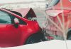 a red car parked next to another red car
