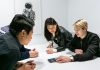 people in a meeting in a white room discussing app development