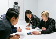 people in a meeting in a white room discussing app development
