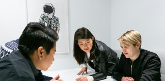 people in a meeting in a white room discussing app development