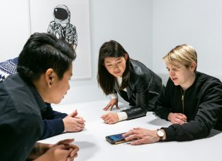 people in a meeting in a white room discussing app development