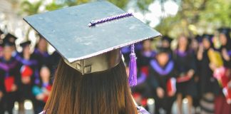 woman wearing academic cap and dress selective focus photography