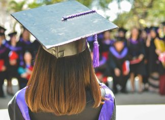 woman wearing academic cap and dress selective focus photography