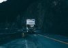 Who Can Be Held Liable in a Truck Accident in Indianapolis? trailer truck passing on road near rail guard