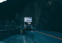 Who Can Be Held Liable in a Truck Accident in Indianapolis? trailer truck passing on road near rail guard