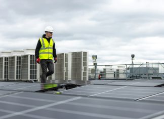 How Routine HVAC Maintenance Extends Equipment Life and Comfort a man standing on top of a roof