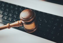 5 Foreign-Language Document Risks That Can Sink a Legal Case in 2026 a wooden gaven sitting on top of a computer keyboard