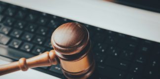 a wooden gaven sitting on top of a computer keyboard