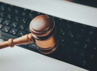 a wooden gaven sitting on top of a computer keyboard