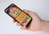 A hand holds a phone with an egyptian-themed game.