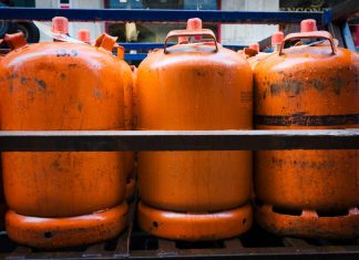 The Invisible Meter Between the Oil Well and Your Gas Tank a group of orange barrels