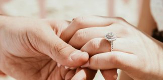 person holding another person's hand with ring