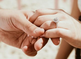 Promise Rings Explained: Meaning, Etiquette and How to Choose One person holding another person's hand with ring