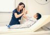 a woman is giving a boy a high five