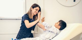 a woman is giving a boy a high five