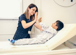 Family Doctor or Pediatrician? Choosing the Right Care for Your Children in Evans, GA a woman is giving a boy a high five