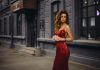 woman in red spaghetti strap dress standing on road during daytime