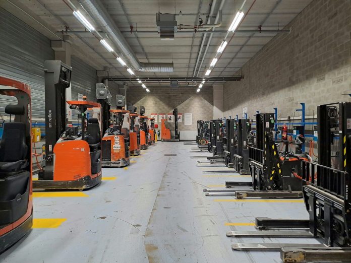 A large warehouse filled with lots of machines