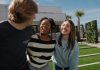 Why Respecting Quiet Hours Improves Community Living Three friends laughing together outdoors on a sunny day